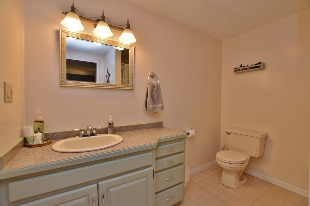 211 Bumstead Road Monson, MA 01057 - Photo 13 of 30 a bathroom with a toilet a sink and mirror