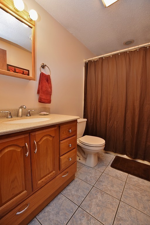 211 Bumstead Road Monson, MA 01057 - Photo 21 of 30 a bathroom with a sink a toilet and mirror