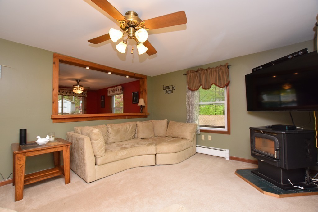 211 Bumstead Road Monson, MA 01057 - Photo 8 of 30 a living room with furniture a flat screen tv and a window