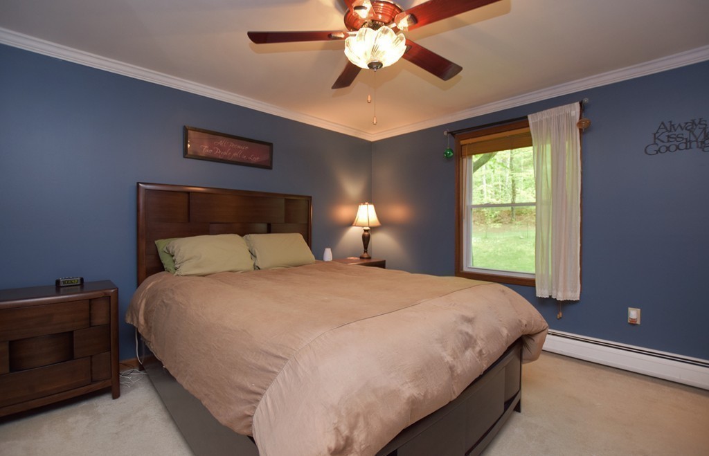 211 Bumstead Road Monson, MA 01057 - Photo 10 of 30 a bedroom with a bed and a chandelier