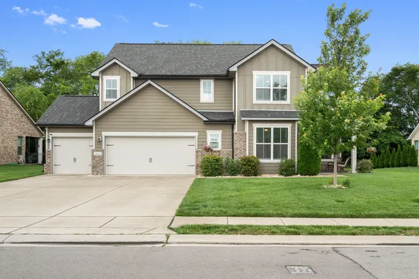 a front view of a house with a yard and garage