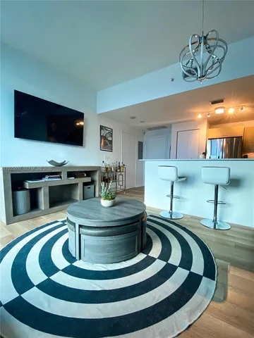 a lobby with furniture and a flat screen tv