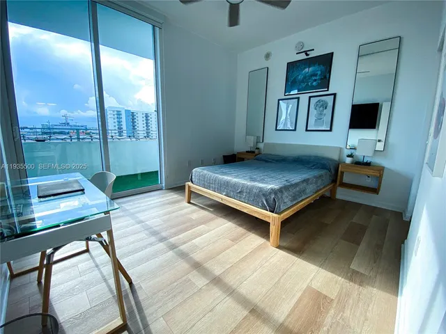 a living room with a bed furniture and next to a window