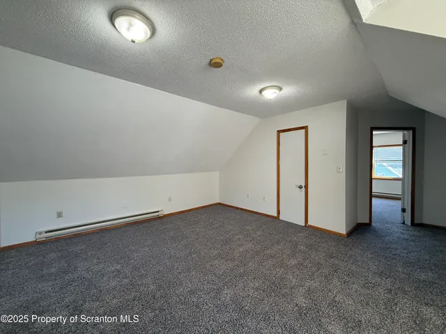 an empty room with closet and mirror