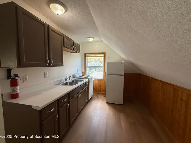 a kitchen with a sink a stove and a refrigerator