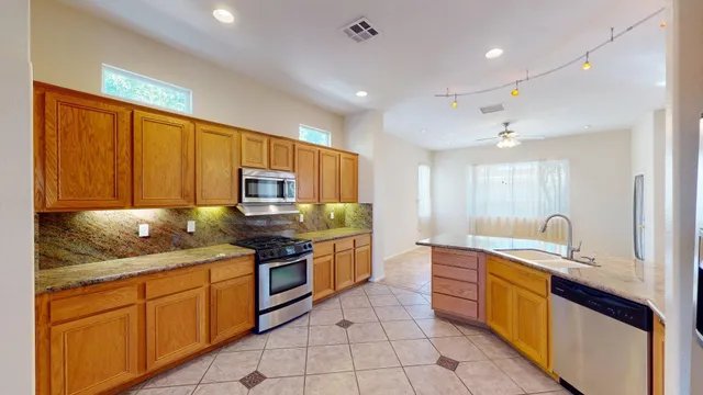 a spacious bathroom with a tub sink and a chandelier
