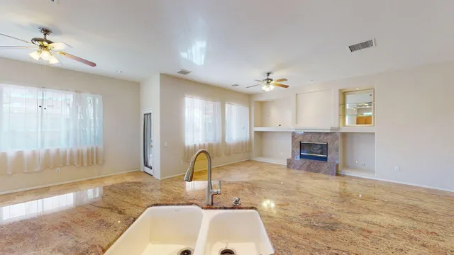a kitchen with stainless steel appliances granite countertop a refrigerator and a stove top oven