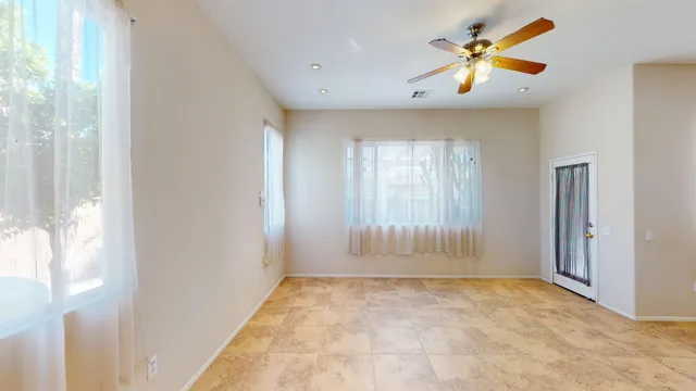 a view of an empty room and kitchen with furniture wooden floor and a kitchen