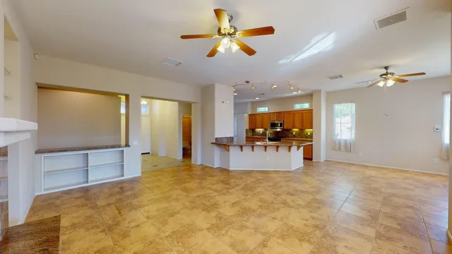 a living room with a couch and a dining table with wooden floor