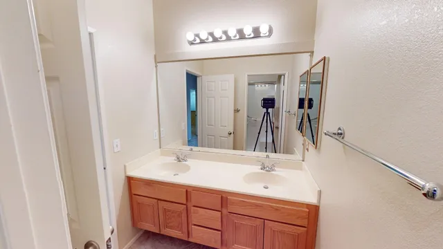 a view of walk in closet and empty room