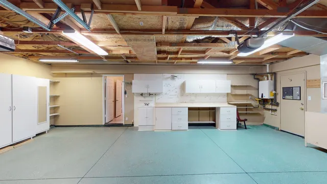 an empty room with a window and a fan