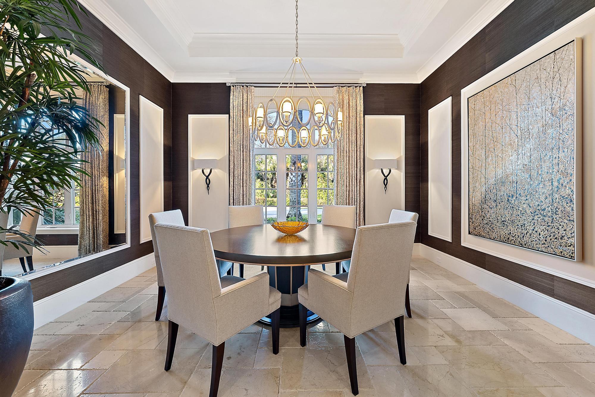 7770 Old Marsh Road Palm Beach Gardens, FL 33418 - Photo 15 of 45 a dining room with furniture a chandelier and wooden floor