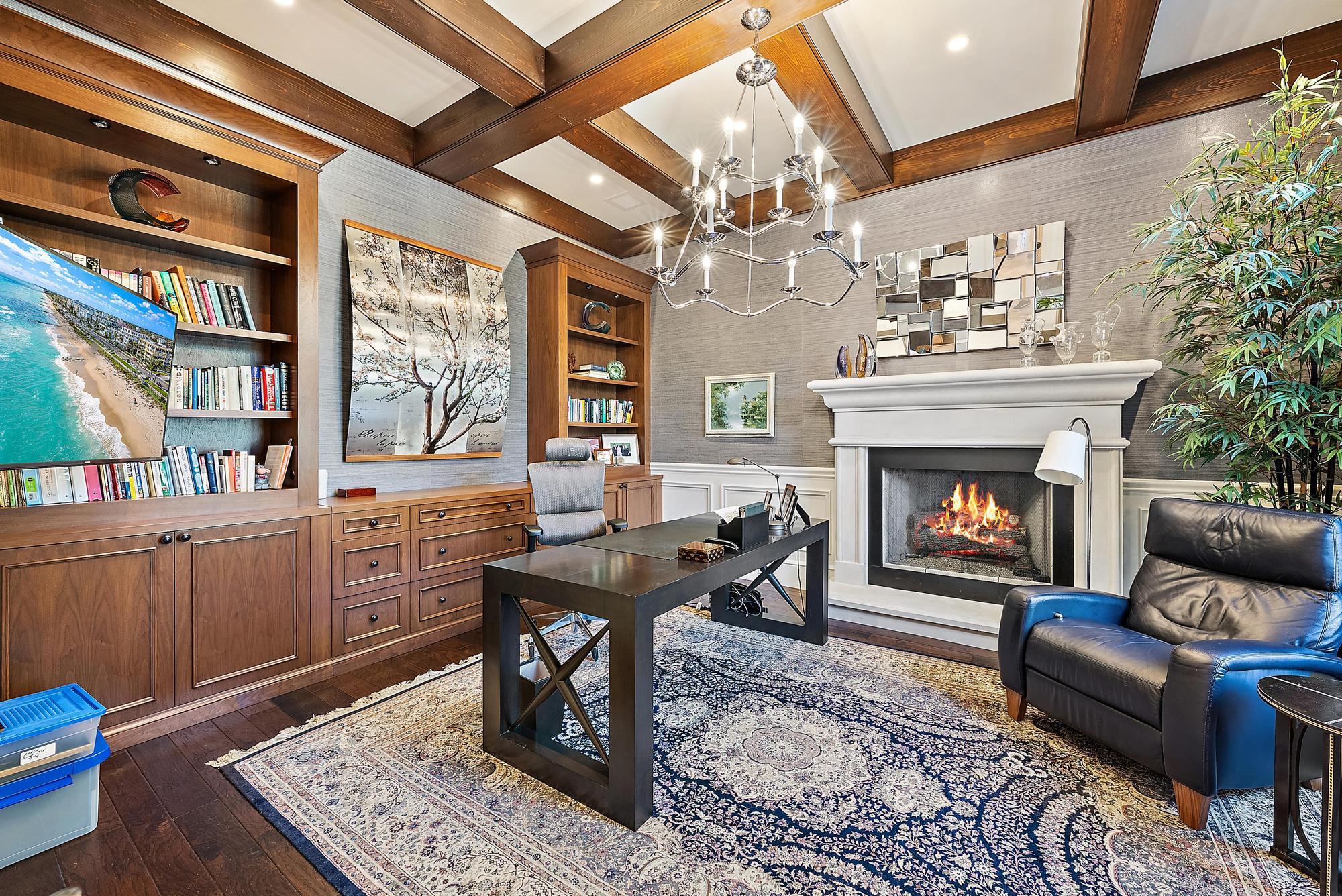 7770 Old Marsh Road Palm Beach Gardens, FL 33418 - Photo 16 of 45 a living room with furniture a fireplace and a chandelier