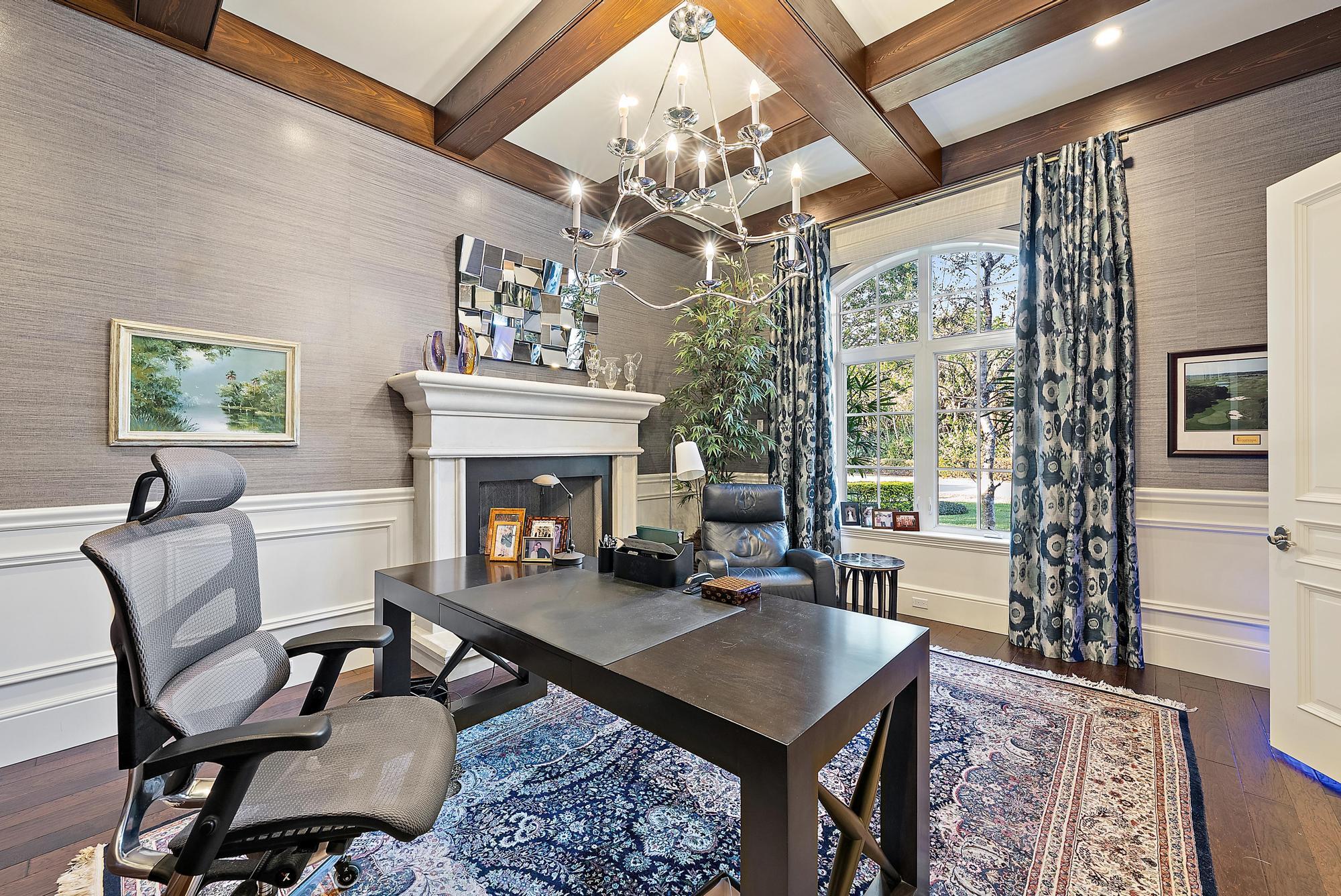 7770 Old Marsh Road Palm Beach Gardens, FL 33418 - Photo 17 of 45 a living room with furniture a table and a fireplace