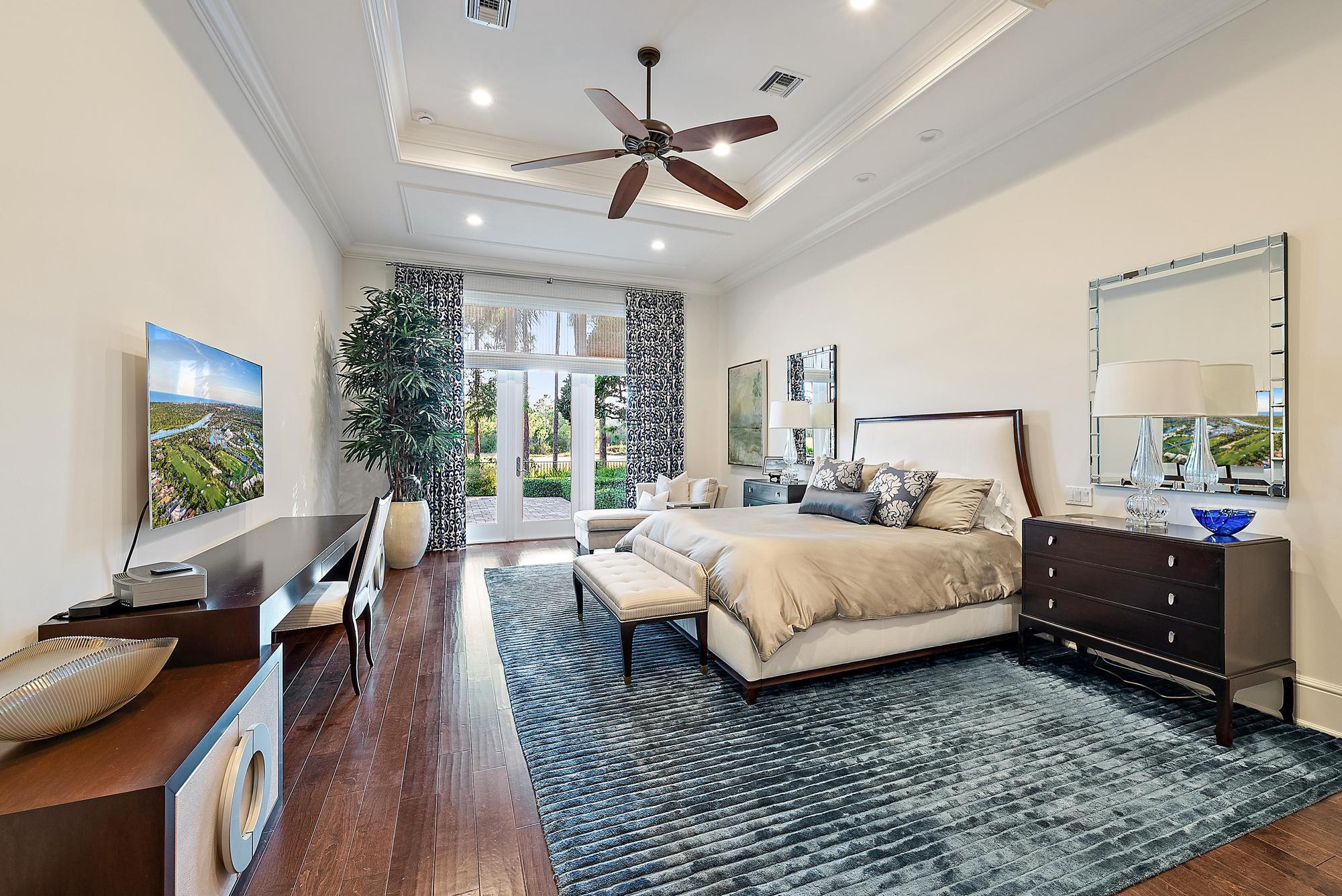 7770 Old Marsh Road Palm Beach Gardens, FL 33418 - Photo 18 of 45 a bedroom with a bed and wooden floor