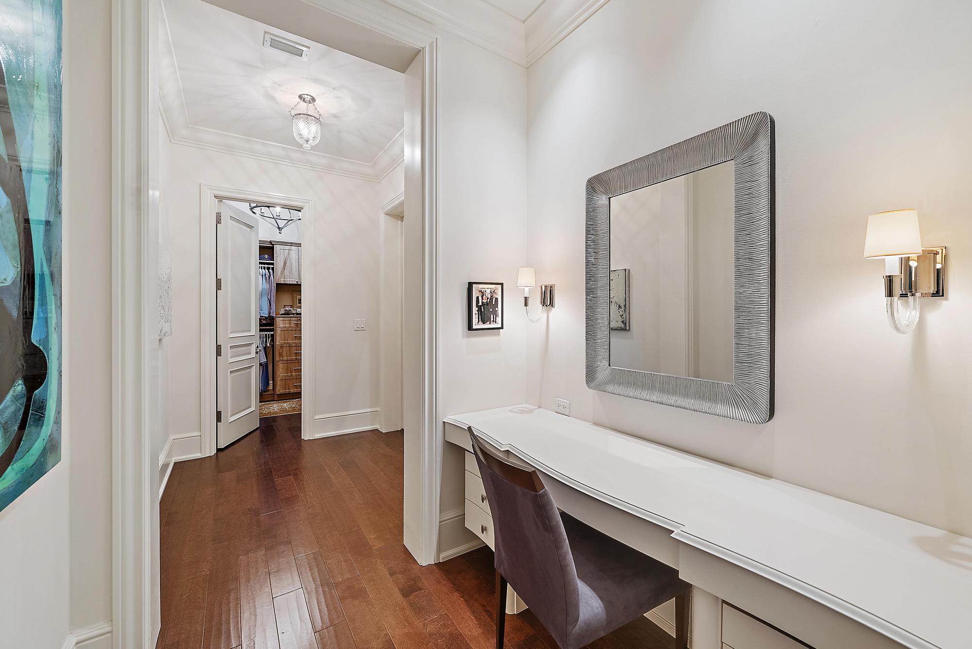 7770 Old Marsh Road Palm Beach Gardens, FL 33418 - Photo 21 of 45 a hallway with a wooden floor a table and chairs