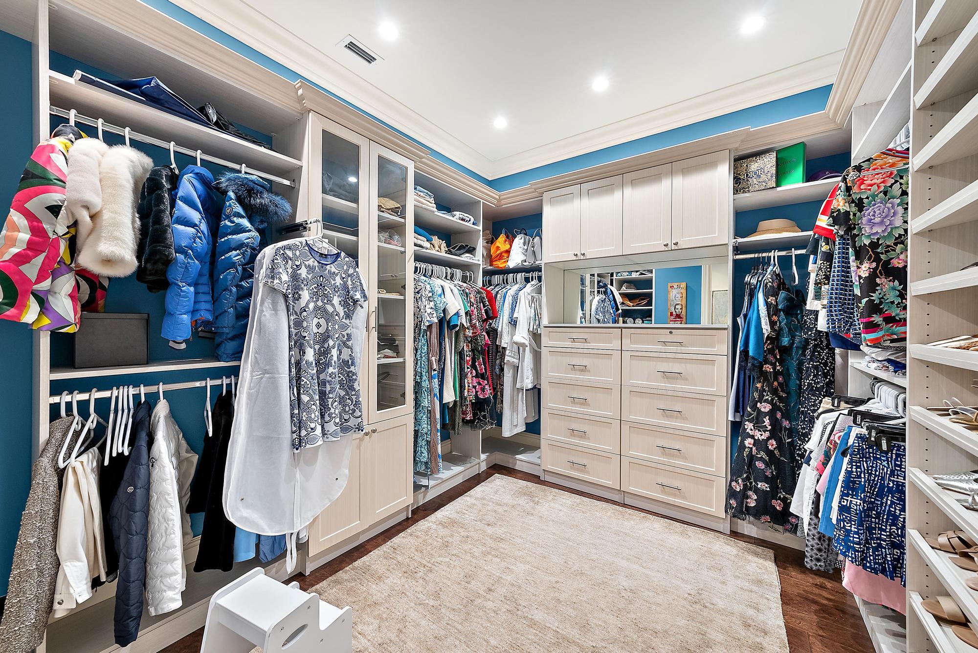 7770 Old Marsh Road Palm Beach Gardens, FL 33418 - Photo 23 of 45 a view of walk in closet with clothes and shoes