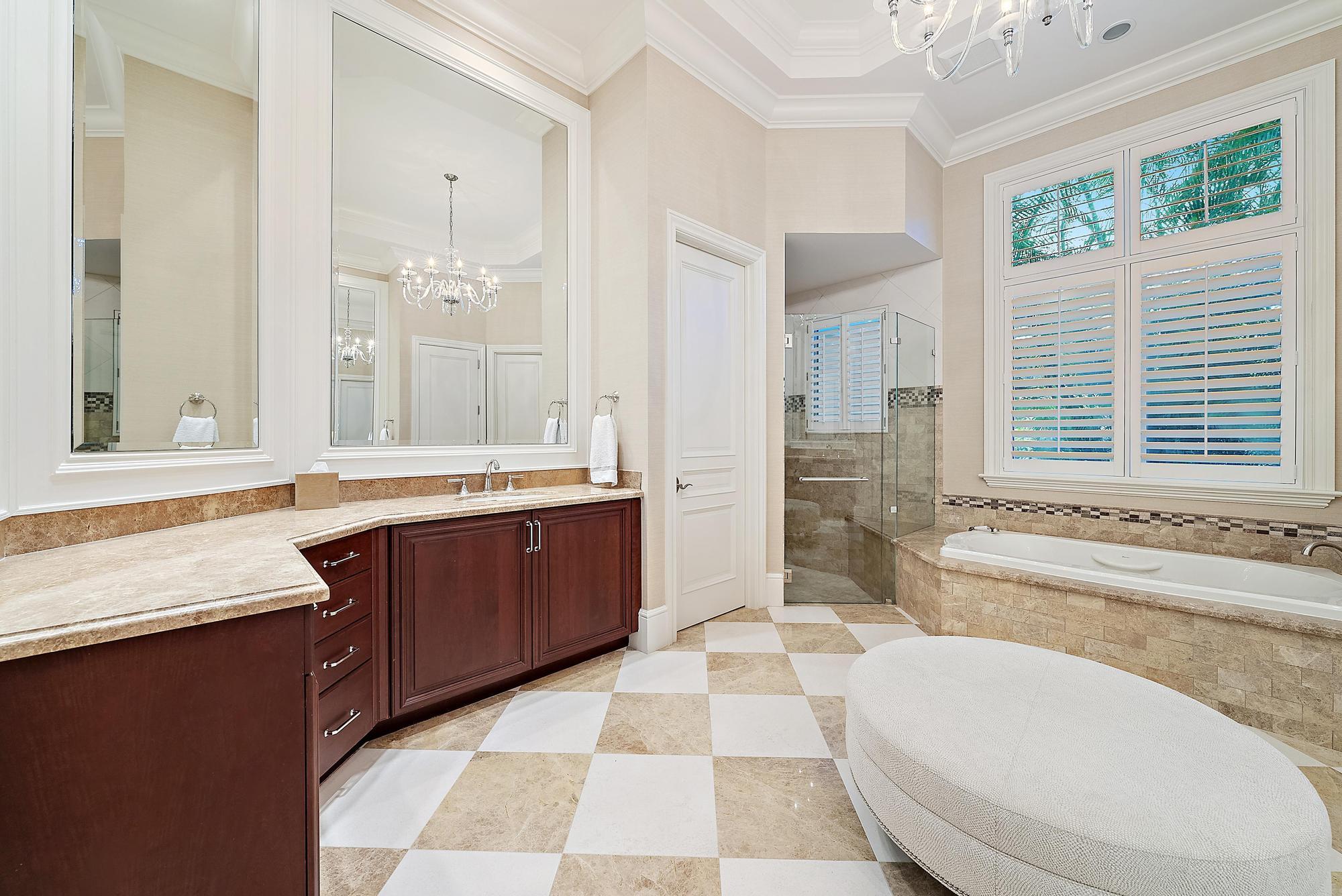 7770 Old Marsh Road Palm Beach Gardens, FL 33418 - Photo 26 of 45 a spacious bathroom with a granite countertop double vanity sink a mirror and a bathtub