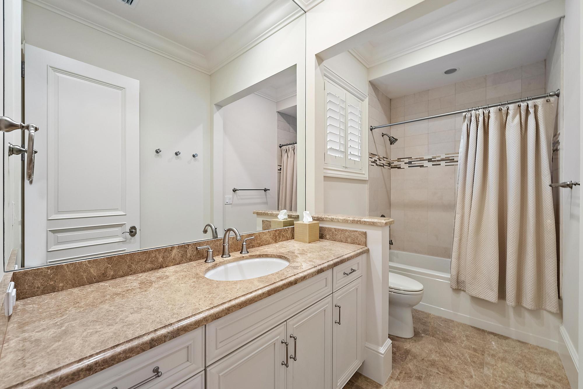 7770 Old Marsh Road Palm Beach Gardens, FL 33418 - Photo 30 of 45 a bathroom with a granite countertop sink toilet and shower