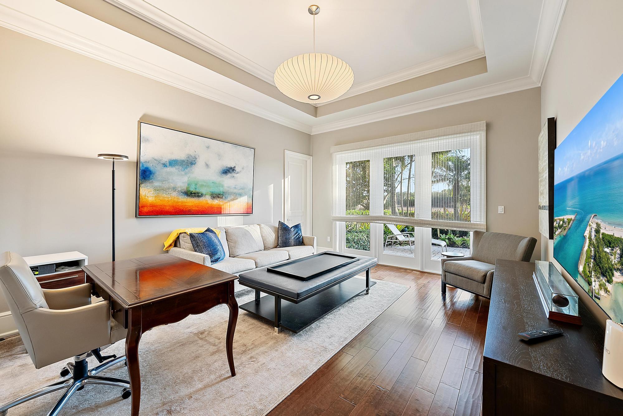 7770 Old Marsh Road Palm Beach Gardens, FL 33418 - Photo 31 of 45 a living room with furniture and a large window