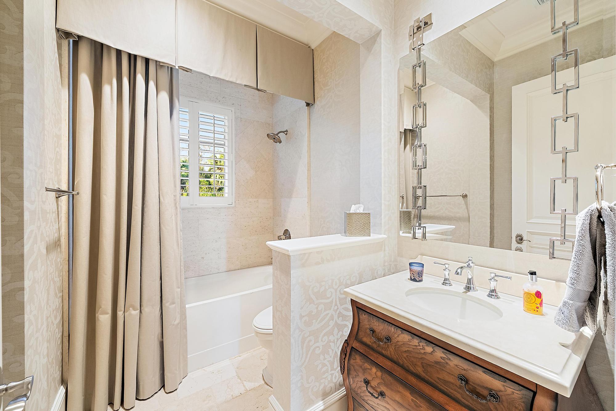 7770 Old Marsh Road Palm Beach Gardens, FL 33418 - Photo 41 of 45 a bathroom with a sink vanity tub and a mirror