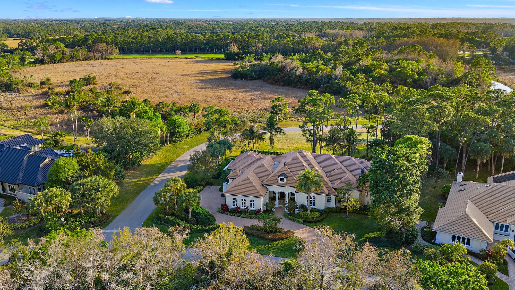 7770 Old Marsh Road Palm Beach Gardens, FL 33418 - Photo 43 of 45 an aerial view of a house with a garden and lake view