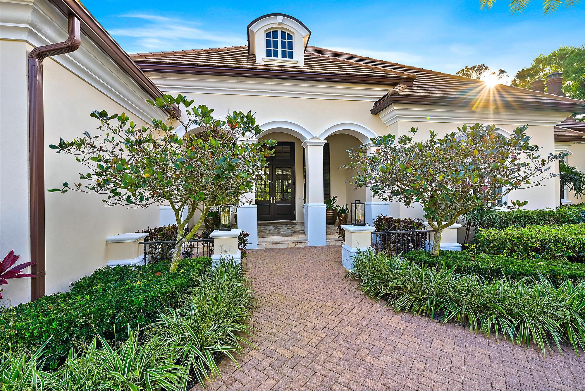 7770 Old Marsh Road Palm Beach Gardens, FL 33418 - Photo 6 of 45 a front view of a house with garden