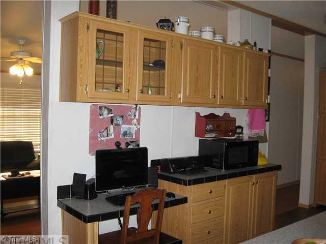 1183 Kallam Farm Road Sandy Ridge, NC 27046 - Photo 5 of 16 Kitchen. Kitchen Desk with Additional Cabinets