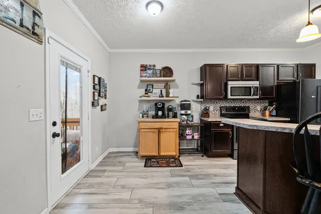 a kitchen with stainless steel appliances a refrigerator a stove top oven a sink and dishwasher