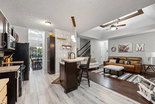 a living room with furniture a piano and a flat screen tv