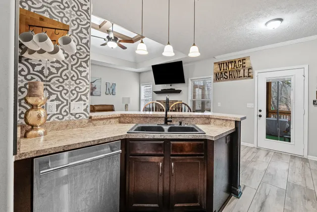 a kitchen with stainless steel appliances granite countertop a sink and a microwave