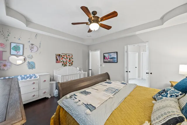 a bedroom with a bed and a chandelier