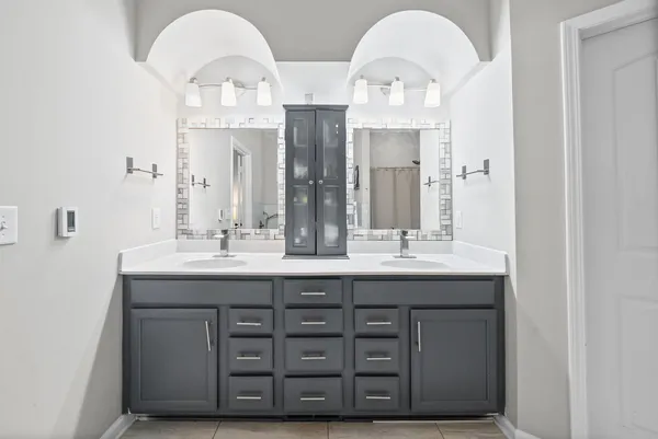 a bathroom with a double vanity sink and a mirror