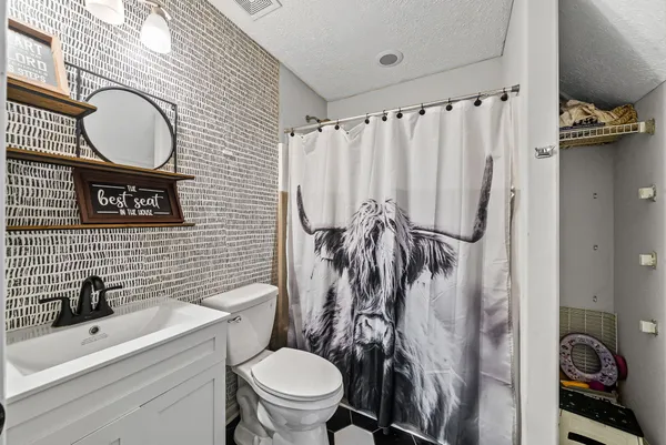 a bathroom with a toilet a sink and a mirror