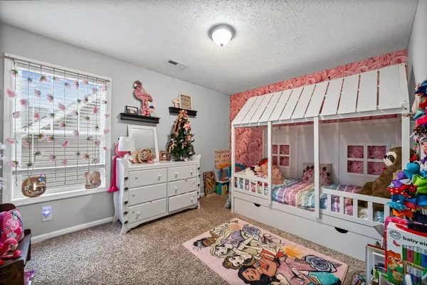 a bed room with furniture and a window