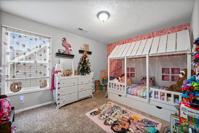 a bed room with furniture and a window