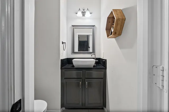 a bathroom with a toilet sink and mirror