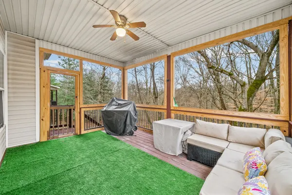 a living room with furniture and a floor to ceiling window