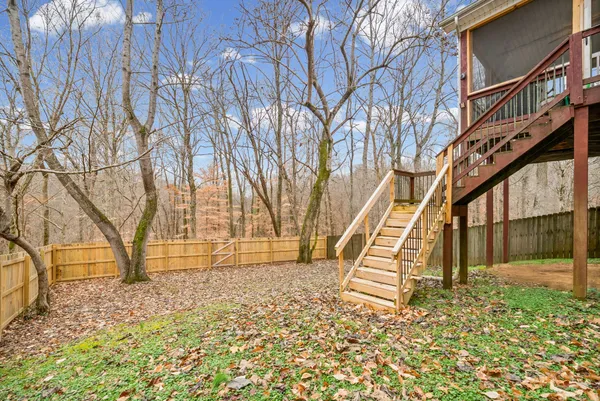 a view of outdoor space with deck and wooden fence