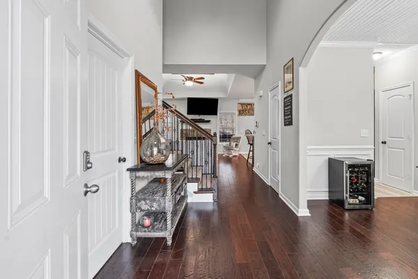 a view of a hallway with wooden floor fireplace and entryway