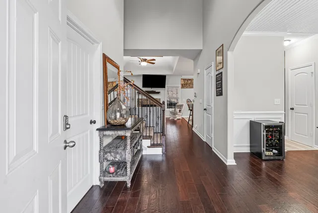 a view of a hallway with wooden floor fireplace and entryway