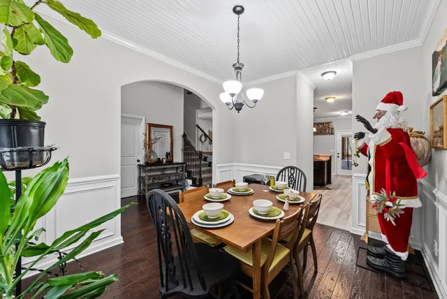 a view of a dining room with furniture wooden floor and chandelier