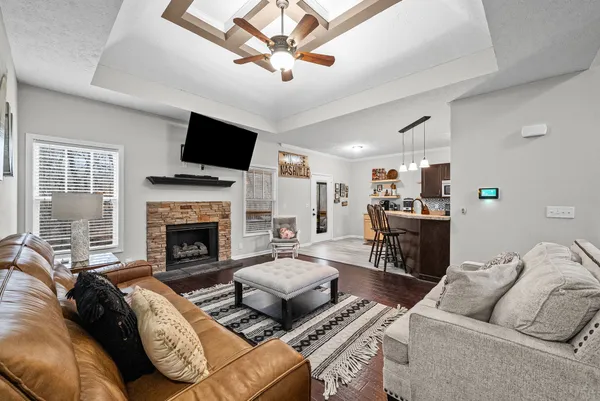 a living room with furniture fireplace and a flat screen tv