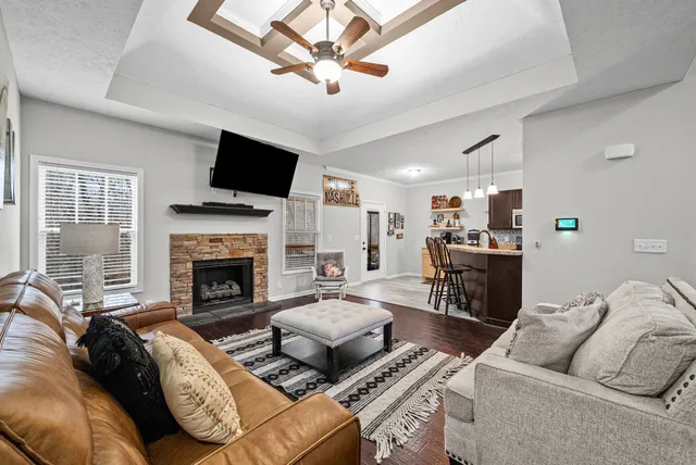 a living room with furniture fireplace and a flat screen tv