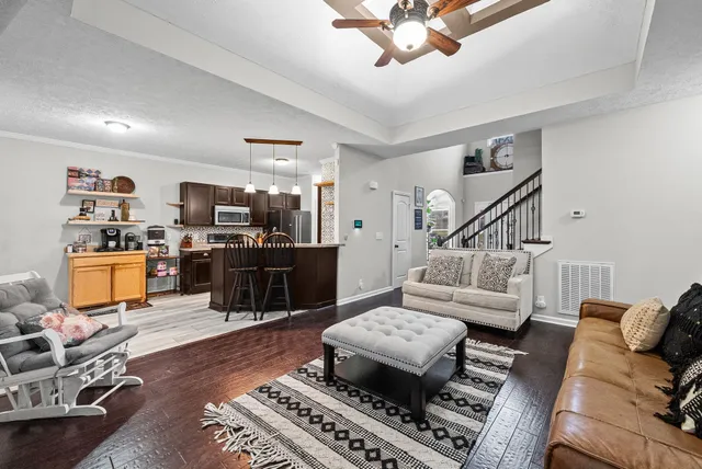 a living room with furniture and wooden floor