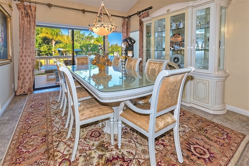 25641 Rapid Falls Road Laguna Hills, CA 92653 - Photo 15 of 50 a dining room with furniture a chandelier and wooden floor
