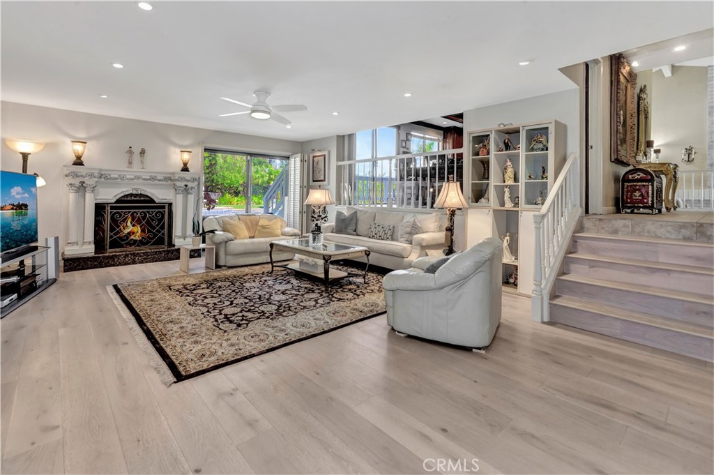 25641 Rapid Falls Road Laguna Hills, CA 92653 - Photo 18 of 50 a living room with furniture and a fireplace