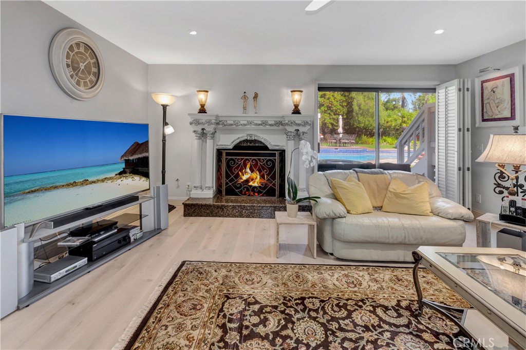 25641 Rapid Falls Road Laguna Hills, CA 92653 - Photo 22 of 50 a living room with furniture and a fireplace