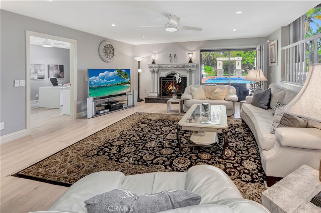 25641 Rapid Falls Road Laguna Hills, CA 92653 - Photo 23 of 50 a living room with furniture a flat screen tv and a fireplace