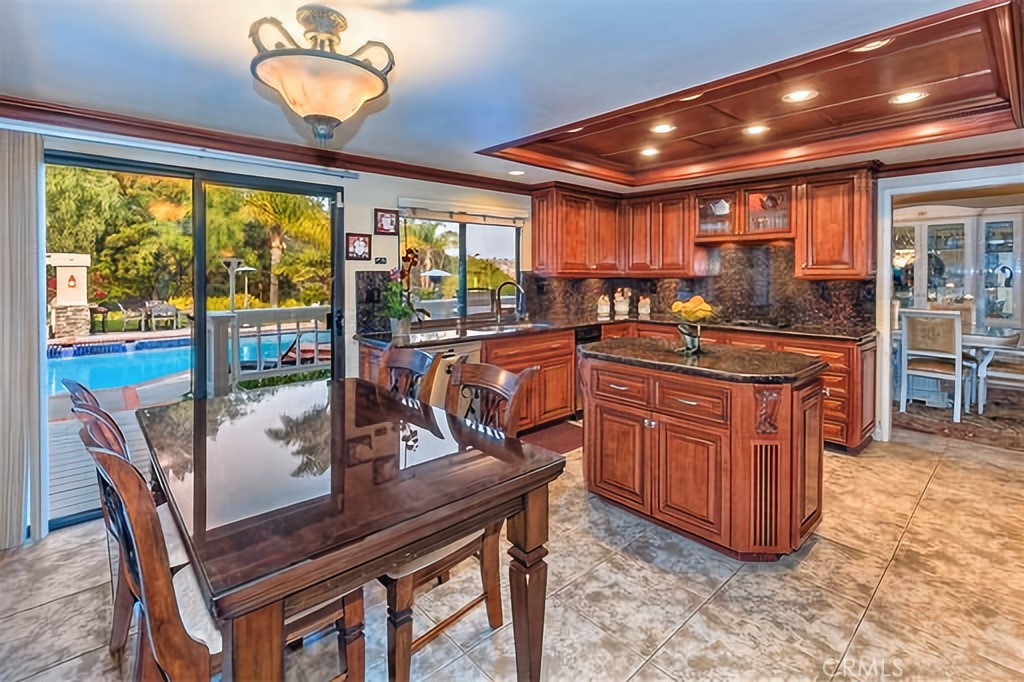 25641 Rapid Falls Road Laguna Hills, CA 92653 - Photo 27 of 50 a view of a dining room with furniture large windows and wooden floor